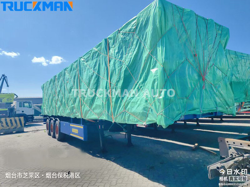 Semi trailer covered with a protective tarpaulin for transportation