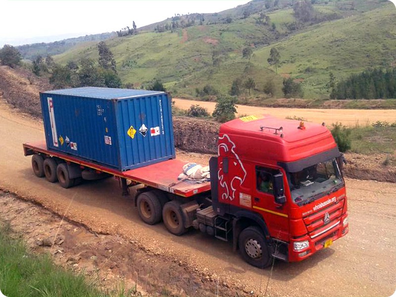 TRUCKMAN flatbed semi trailer carrying a 20ft container